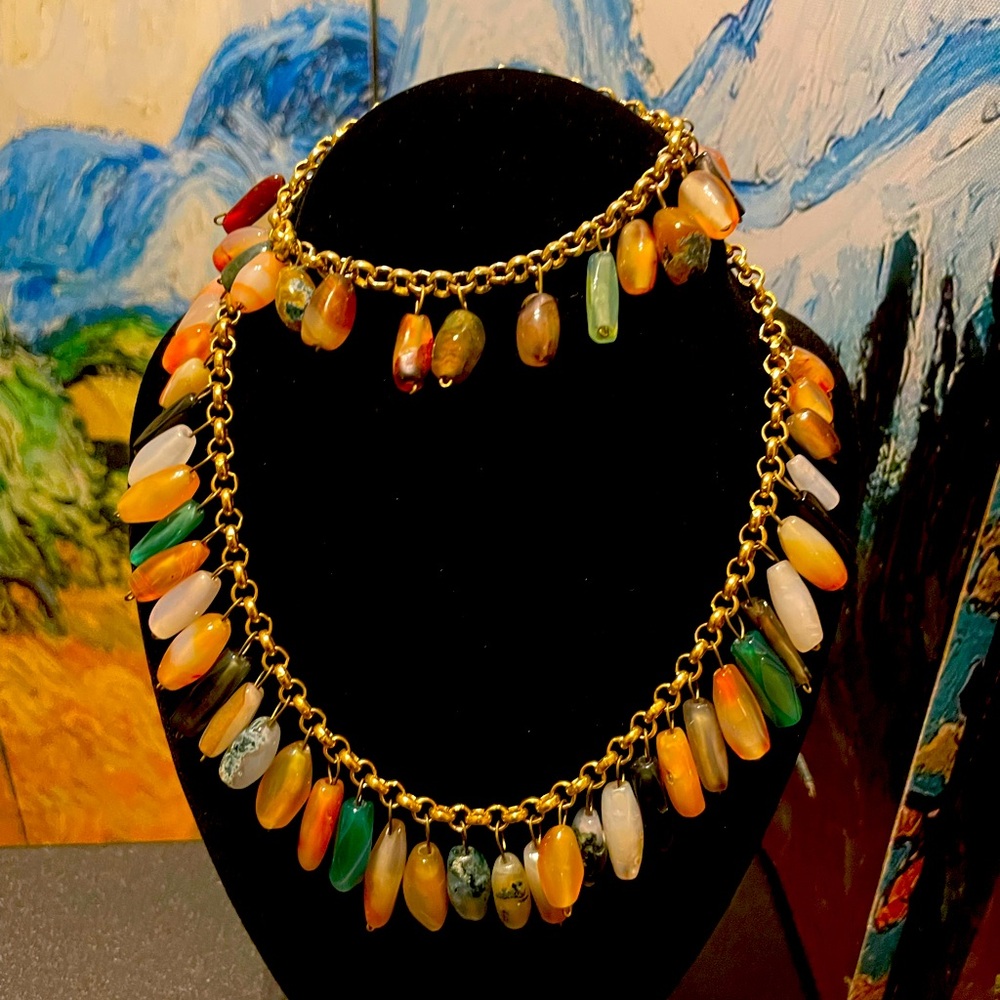 Handmade necklace and bracelet with multicolored beads on gold-colored chain